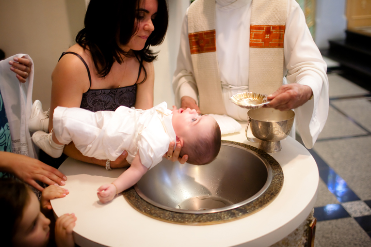 Toronto Baptism Photographer - child being Baptised