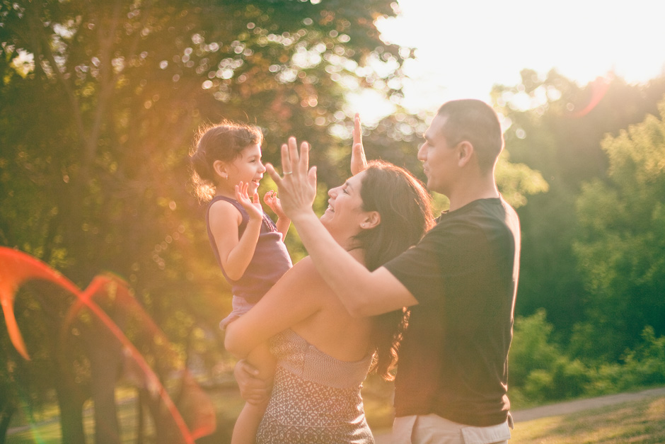 Family playing together in High Park Toronto : happy in the sunlight