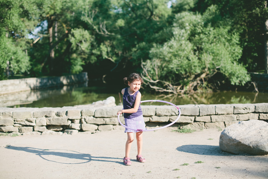 Girl playing with hula hoop in High Park 