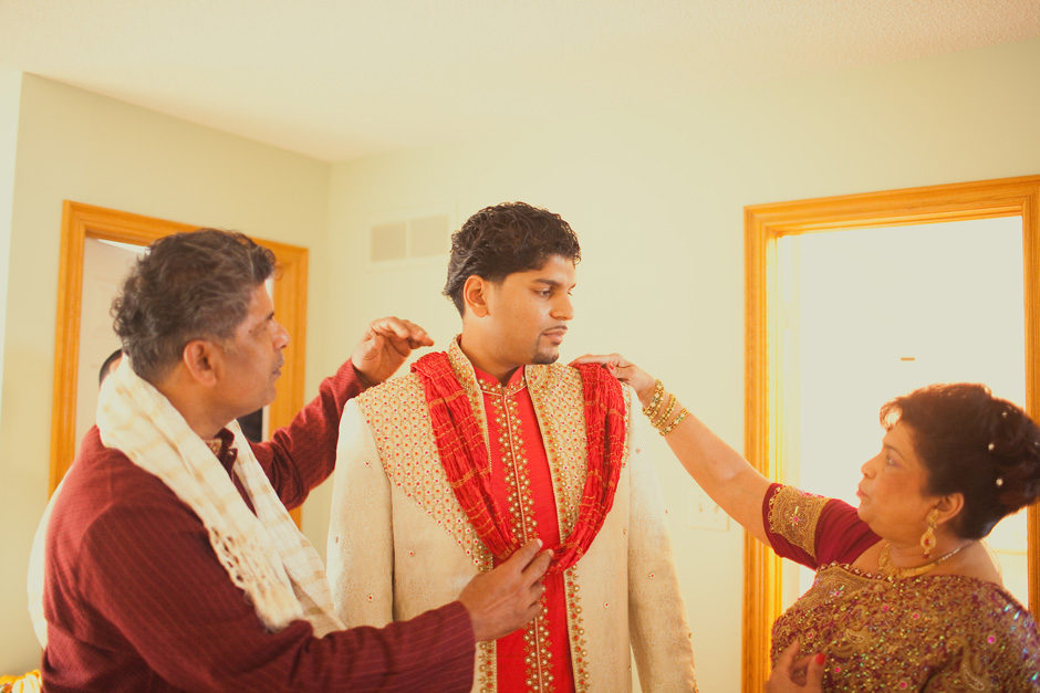 Toronto West Indian Wedding photography : parents helping Arvin get ready for his wedding
