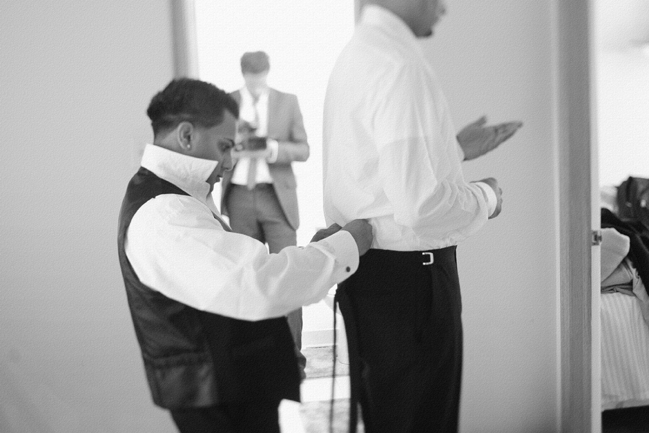 Toronto West Indian Wedding photo : best man helping groom get ready for his wedding
