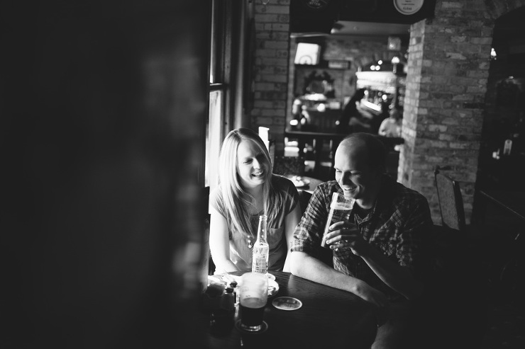 Toronto Engagement Photographer: couple drinking beer in pub 