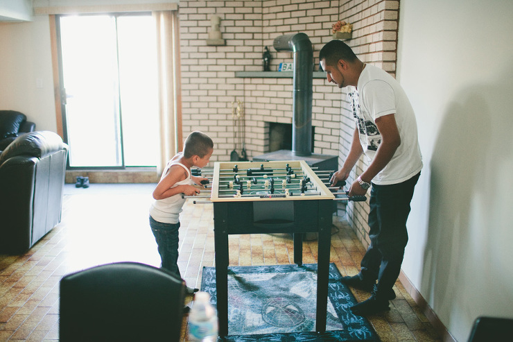 Toronto Documentary Family Photographer : playing foosball with dad