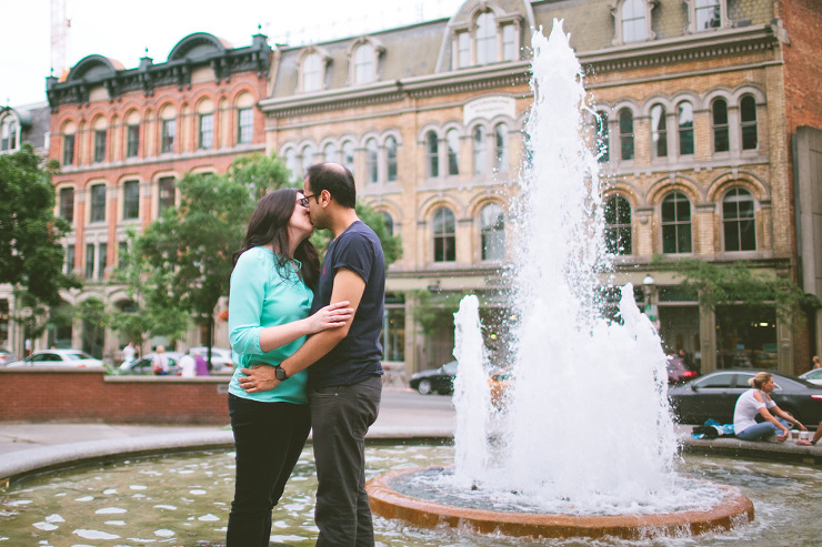 Toronto Engagement Photographers couple kissing by fountain