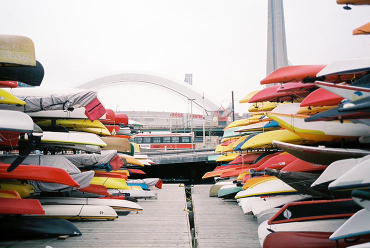 Rogers Centre and CN Tower and canoes and kayaks and streetcar in Toronto