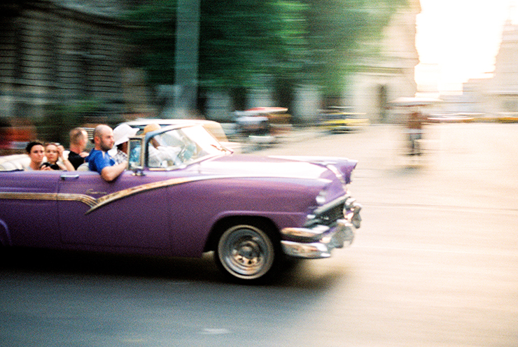 Purple Classic Car in Havana Cuba Cruising down the road