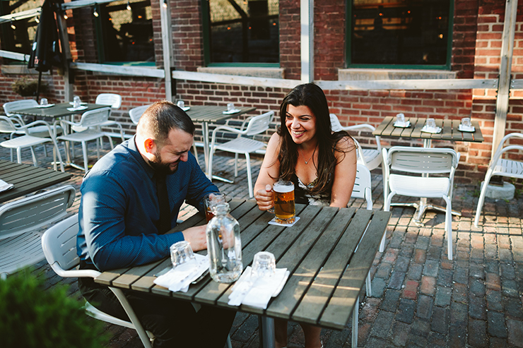 Couple drinking beer engagement photos at Toronto Distillery District
