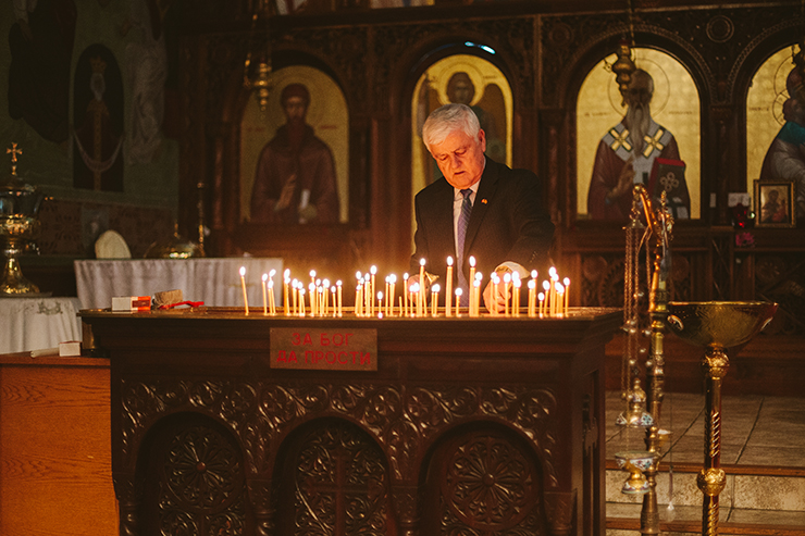 Man Lighting candle at Macedonian Church in Toronto