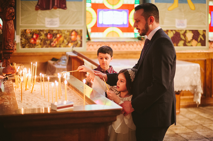 Child Lighting candle at Macedonian Church in Toronto